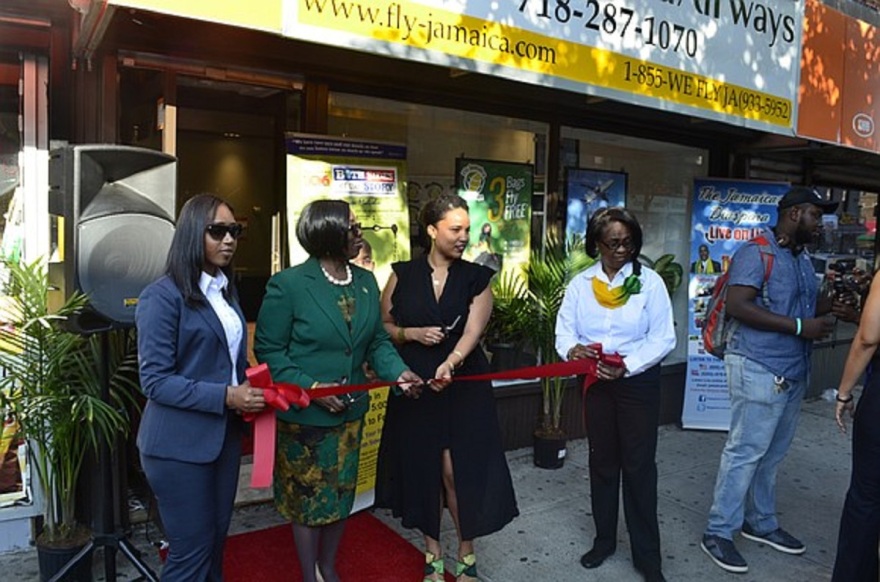 ribbon cutting ceremony outside of a store-front Fly Jamaica Airwaysoffice